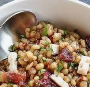 The best easy wheat berry salad with sliced blood oranges, crumbled feta cheese, and red onion vinaigrette in a rustic bowl.